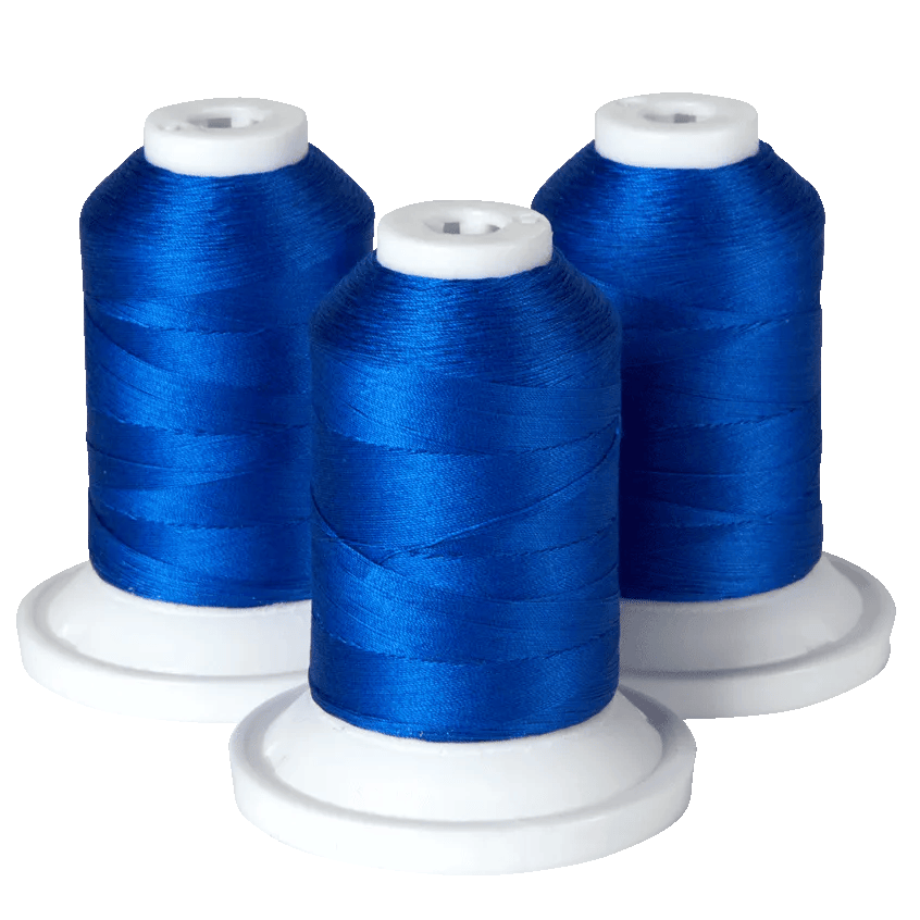 Three spools of blue embroidery thread on white bases for Brother sewing machines