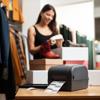 Brother label printer printing shipping labels on retail counter