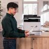 Man printing document on Brother MFC-L8730CDW all-in-one color laser printer in home office