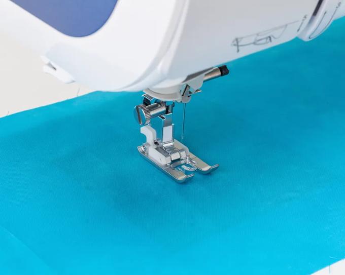 Brother sewing machine presser foot stitching turquoise fabric