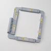Brother embroidery hoop frame with gray border and yellow warning labels