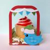 Cupcake with red frosting in decorative carrier with blue bird and festive bunting