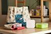 Brother P-touch Cube wireless label maker with labeled lunch containers and tote bag