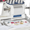 Brother embroidery machine stitching colorful butterfly and floral design on white fabric