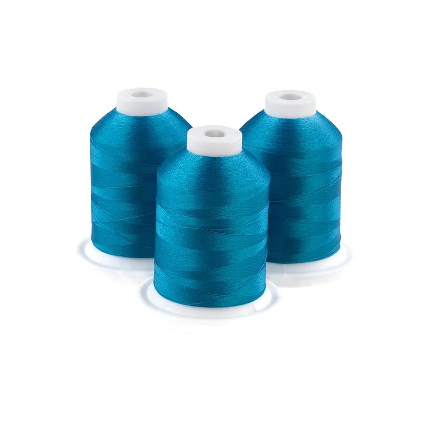 Three aqua embroidery thread spools on white bases