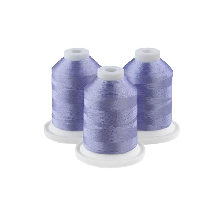 Three soft purple embroidery thread spools on white bases