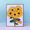 Handmade paper sunflower bouquet card with kraft border and twine bow on blue background