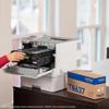Hand replacing toner cartridge in Brother HL-L8570CDW color laser printer