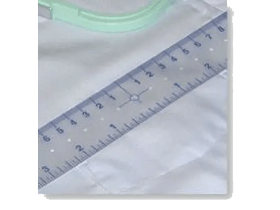 Brother ScanNCut ruler measuring fabric with green cutting mat in background