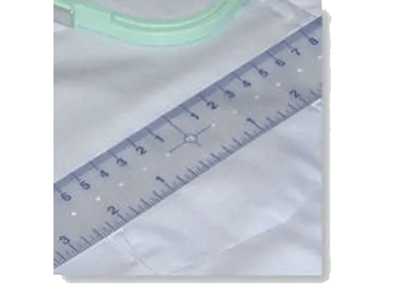Brother ScanNCut ruler measuring fabric with green cutting mat in background