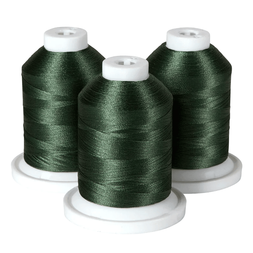 Three spools of dark green embroidery thread on white bases