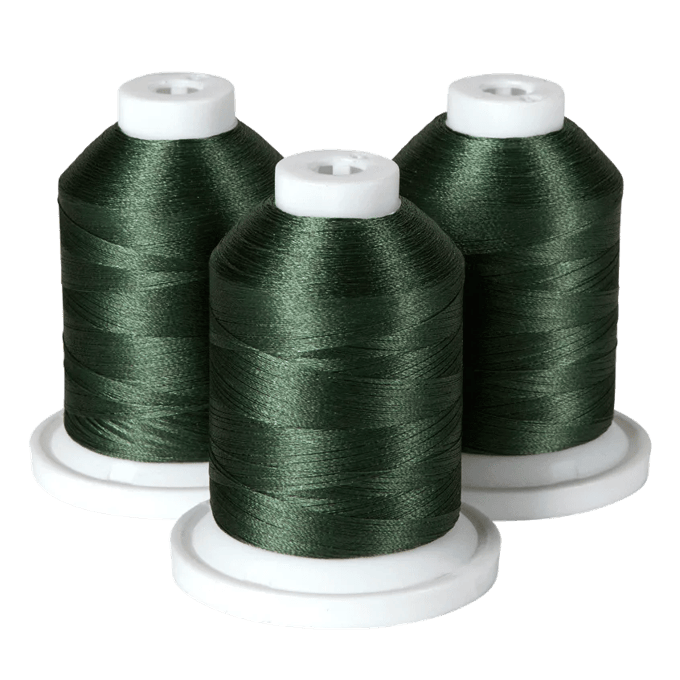 Three spools of dark green embroidery thread on white bases