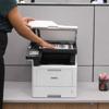 Person scanning document on Brother MFC-L5710DN all-in-one laser printer in office