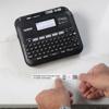 Brother P-touch wireless label maker with QWERTY keyboard displaying scan prompt for QR code menu