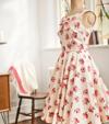 Floral print dress on mannequin in bright sewing room with Brother sewing machine