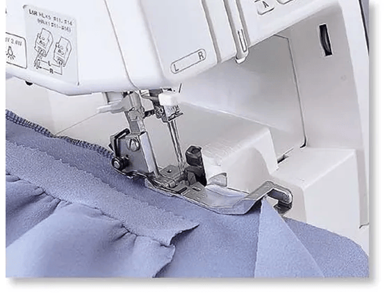 Brother serger machine sewing blue fabric with differential feed and overlock stitch