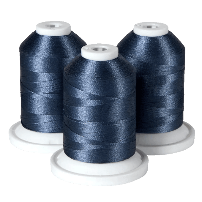 Three spools of navy blue embroidery thread on white bases