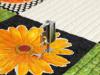 Brother sewing machine presser foot on embroidered floral fabric with decorative stitching