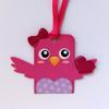 Pink owl-shaped gift tag with bow and ribbon attachment