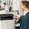 Professional using smartphone to print from Brother MFC-L8905CDW color laser all-in-one in office