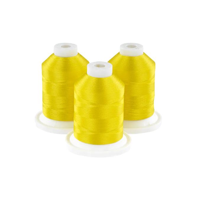 Three yellow embroidery thread spools on white bases