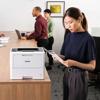 Woman reviewing printed document from Brother HL-L6210DW monochrome laser printer in office