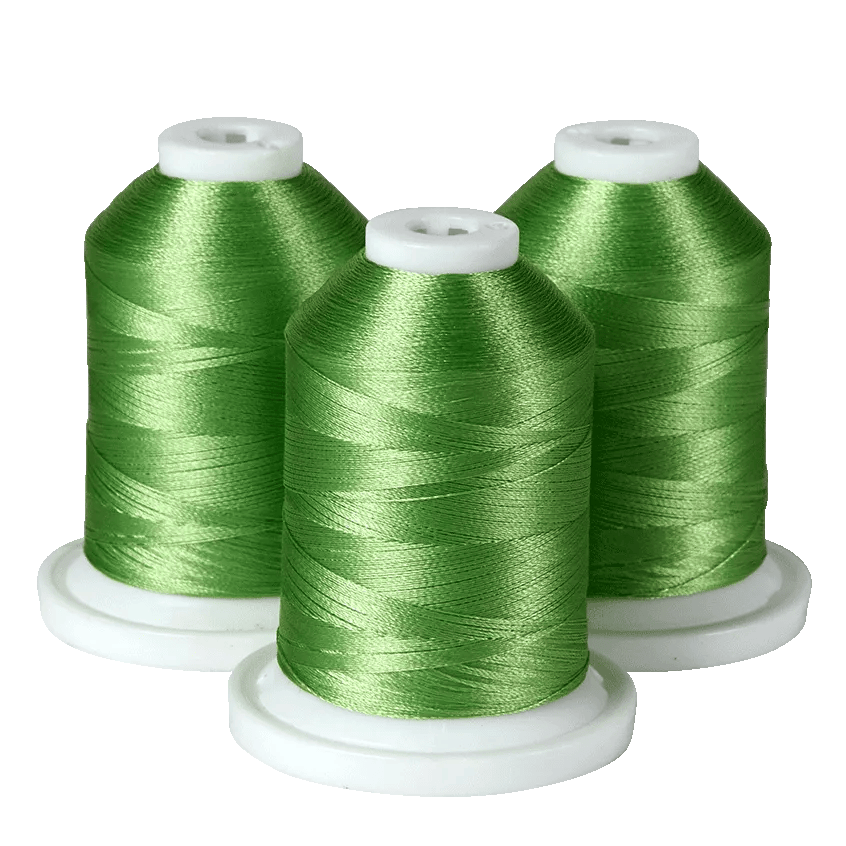 Three green embroidery thread spools on white bases for Brother sewing machines