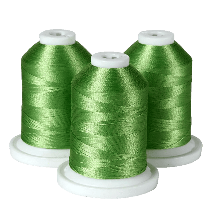 Three green embroidery thread spools on white bases for Brother sewing machines