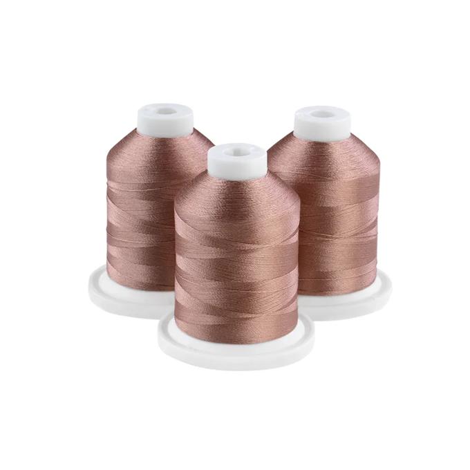 Three taupe embroidery thread spools on white bases