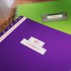 Brother label on purple notebook with green spiral notebook and label maker in background