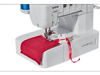 Brother cover stitch machine sewing red fabric with visible needle and thread