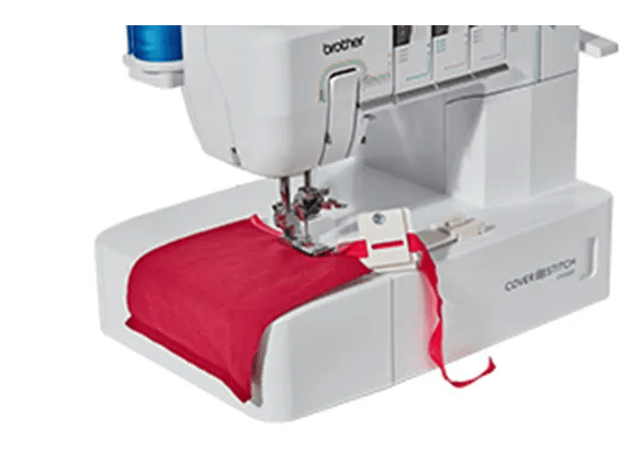 Brother cover stitch machine sewing red fabric with visible needle and thread