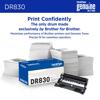 Brother DR830 drum unit with packaging beside stacks of printed paper