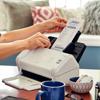 Brother portable scanner printing receipt on home office desk