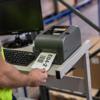 Brother TD-4420TN desktop label printer printing barcode label in warehouse setting