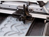 Brother ScanNCut cutting machine blade cutting intricate pattern on gray material