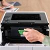 Hand installing Brother DR920 drum unit into laser printer