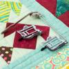 Brother quilting guide bar and feet on colorful patchwork quilt