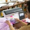 Brother NQ3700D sewing and embroidery machine with touchscreen stitching colorful fabric