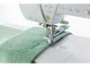 Brother sewing machine stitching green felt fabric with button attachment foot