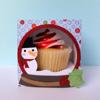 Vanilla cupcake with red and white frosting in festive snowman gift box