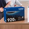 Brother TN920V high-yield toner cartridge box on office desk with printer