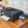 Brother MFC-J1010DW all-in-one wireless printer with LC401XL high-yield ink cartridge 3-pack on desk