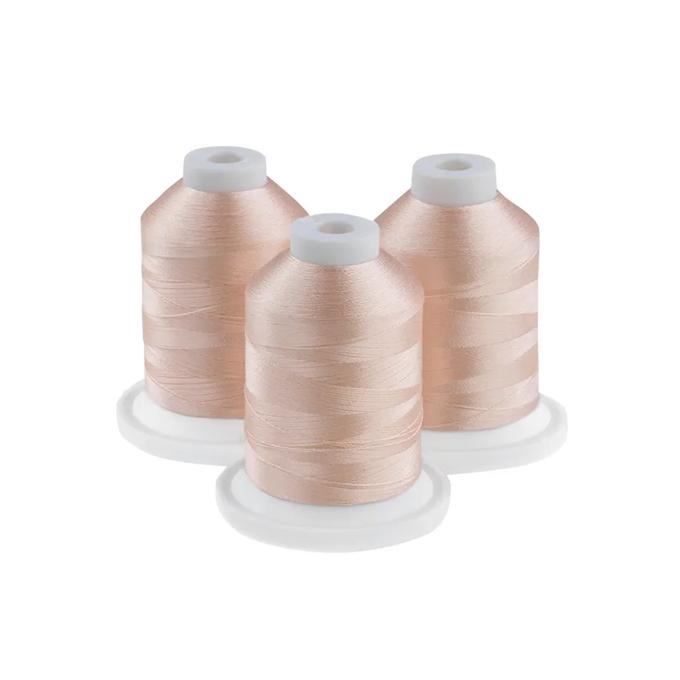Three spools of soft opal embroidery thread on white bases