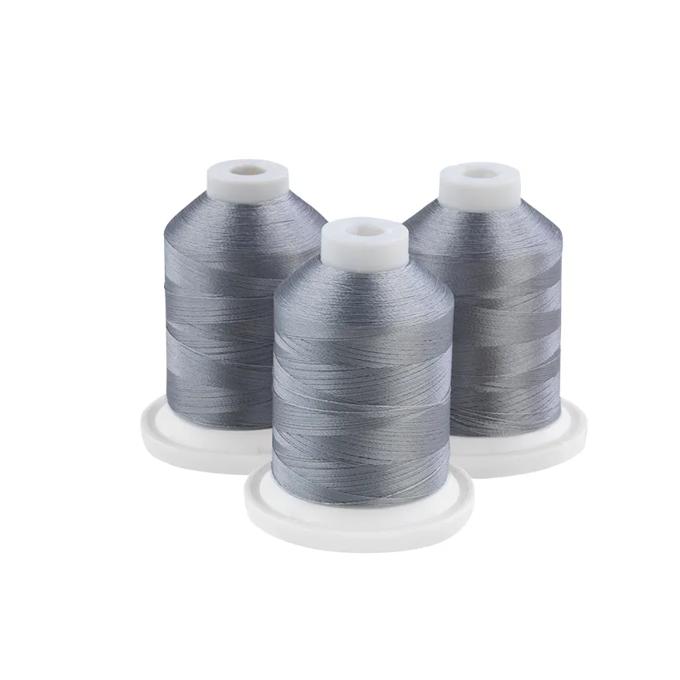 Three grey embroidery thread spools on white bases
