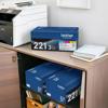 Brother TN221 3-pack toner cartridges on desk with wireless all-in-one laser printer