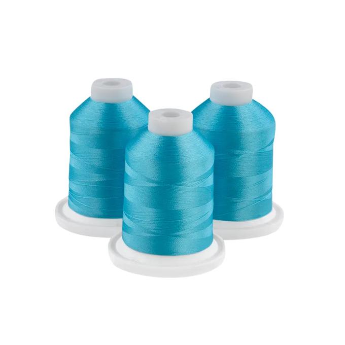 Three teal embroidery thread spools on white bases