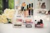 Brother-labeled acrylic makeup organizer with drawers, cosmetics, brushes, and white roses