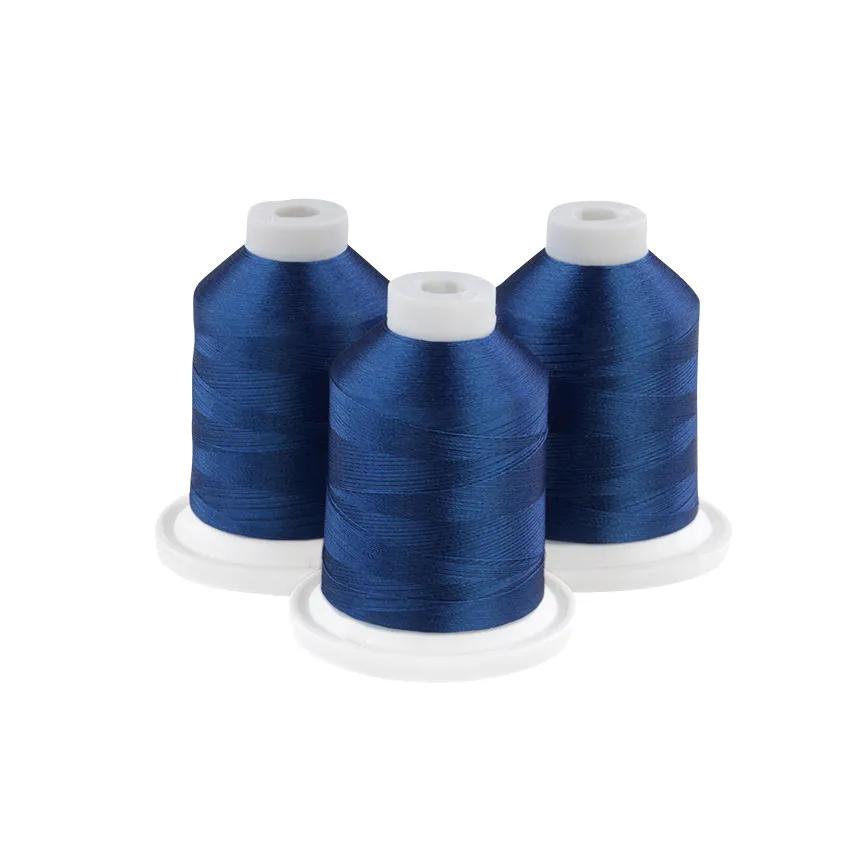 Three spools of gem blue embroidery thread on white bases