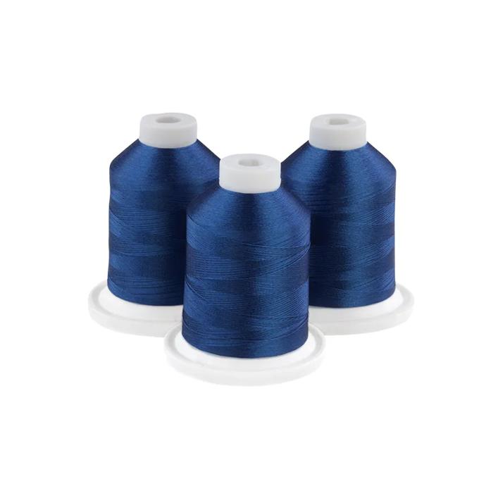 Three spools of gem blue embroidery thread on white bases